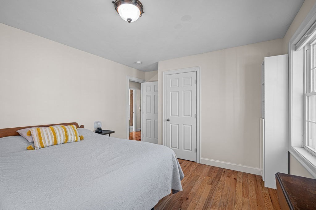 10 Caitlin Road Salisbury, MA 01952 - Photo 25 of 33 a bedroom with a bed and wooden floor