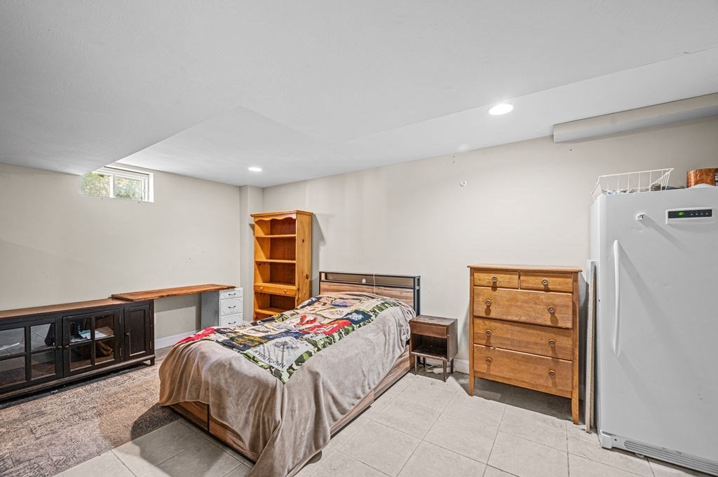 10 Caitlin Road Salisbury, MA 01952 - Photo 27 of 33 a bedroom with a bed a dresser and a large window