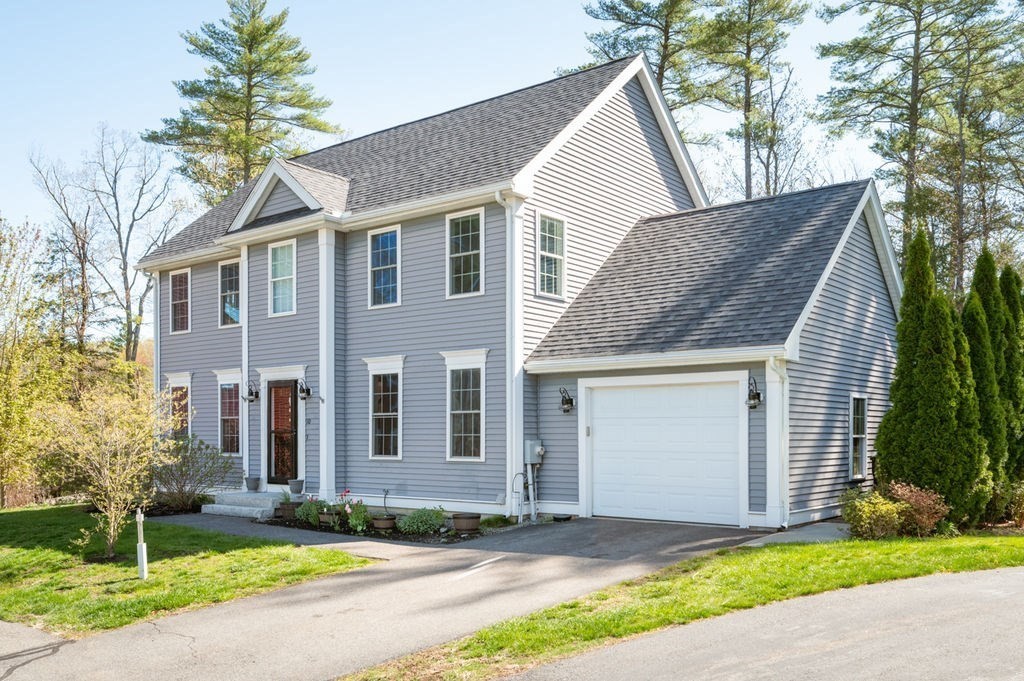 10 Caitlin Road Salisbury, MA 01952 - Photo 3 of 33 a front view of a house with a yard and garage