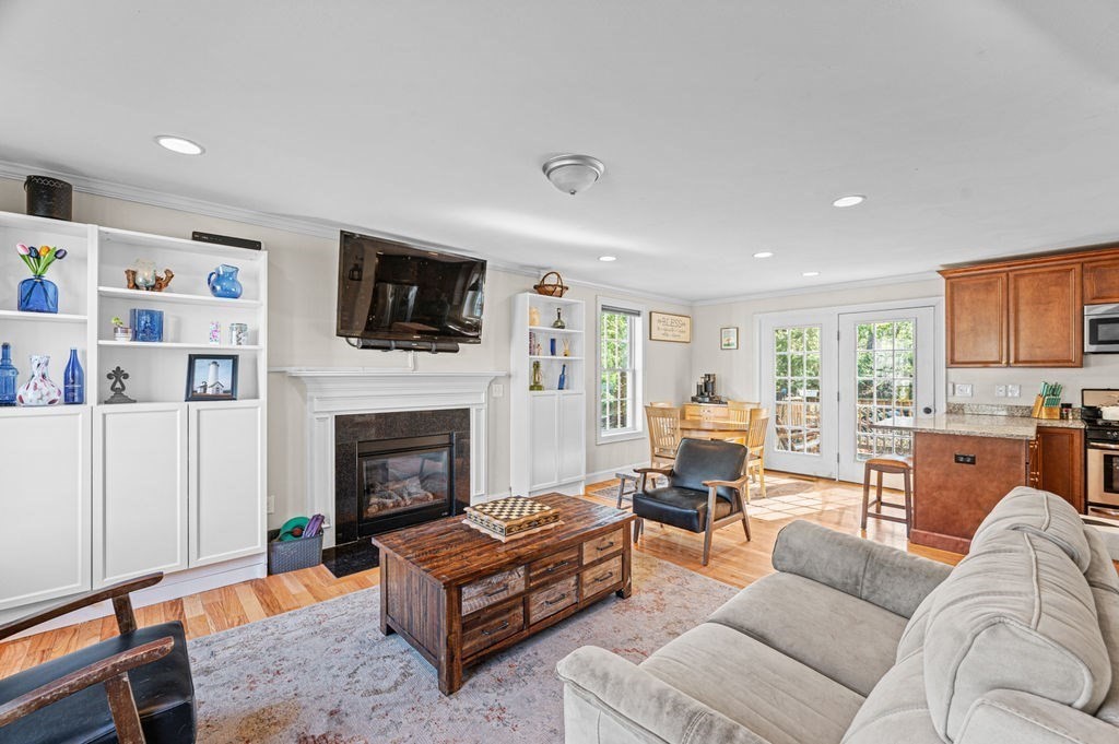 10 Caitlin Road Salisbury, MA 01952 - Photo 6 of 33 a living room with furniture a fireplace and a flat screen tv