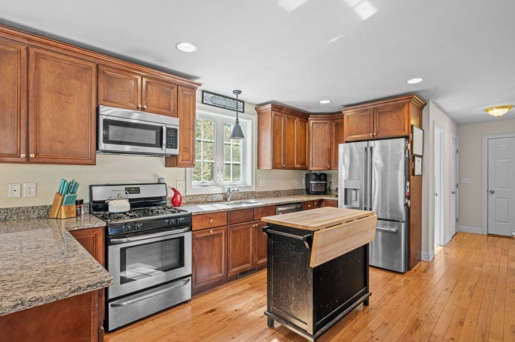 10 Caitlin Road Salisbury, MA 01952 - Photo 10 of 33 a kitchen with wooden cabinets and stainless steel appliances