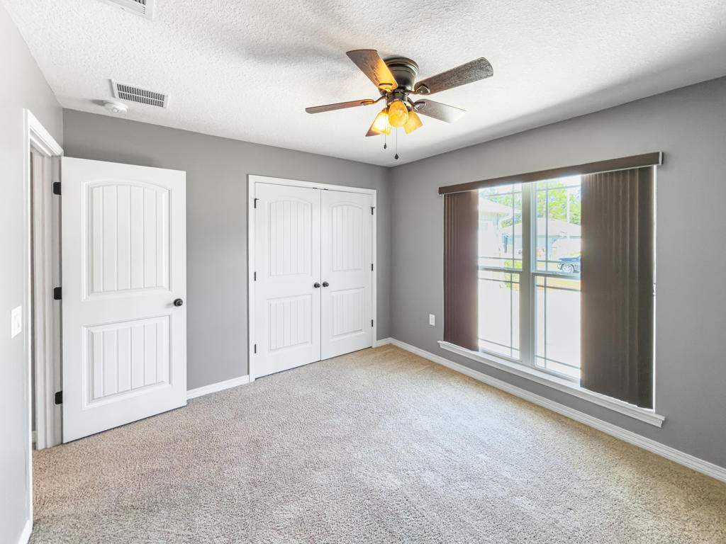 125 Lillian Way Crestview, FL 32536 - Photo 16 of 33 an empty room with window and ceiling fan