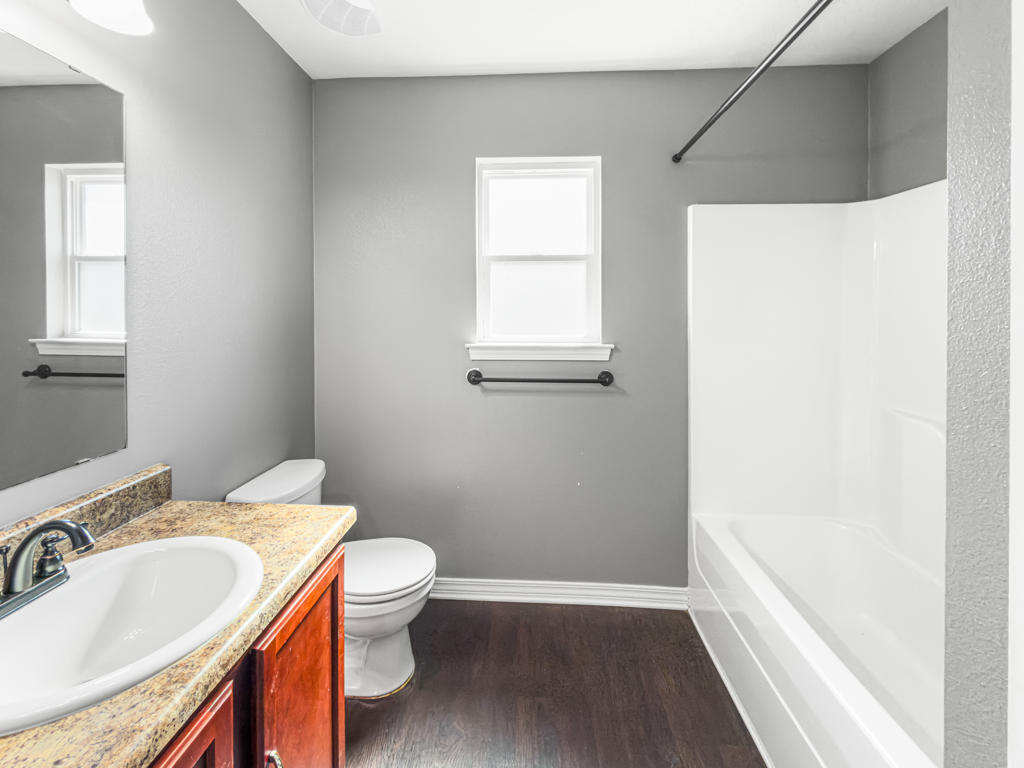 125 Lillian Way Crestview, FL 32536 - Photo 17 of 33 a bathroom with a granite countertop sink a toilet and a bathtub