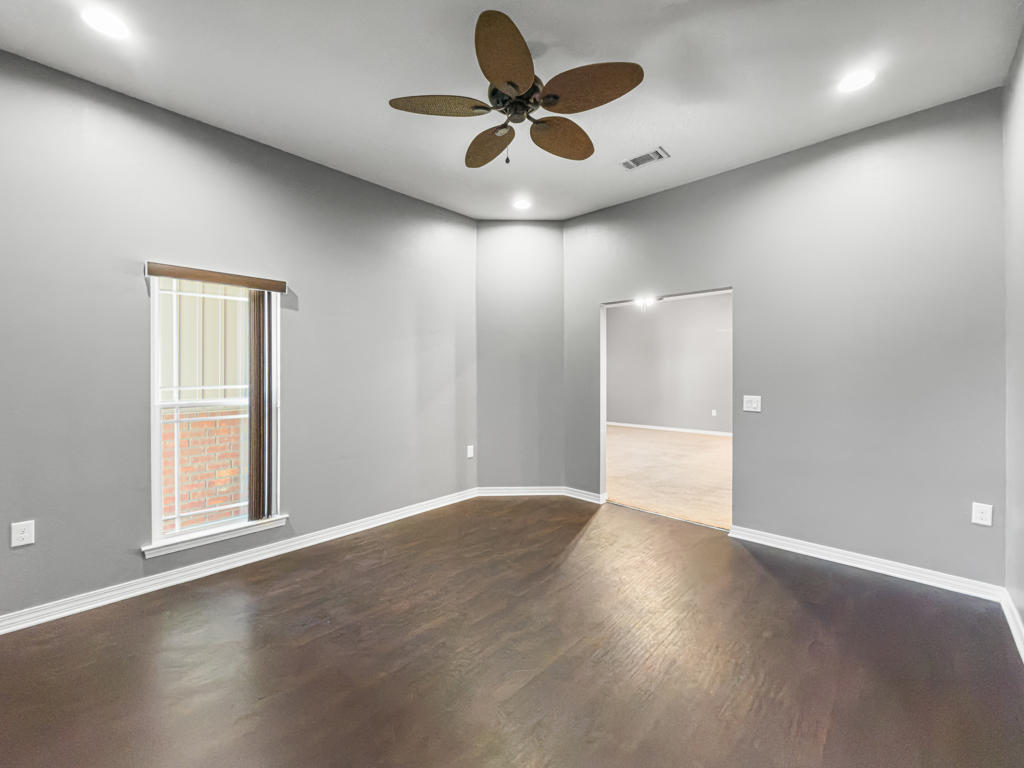 125 Lillian Way Crestview, FL 32536 - Photo 22 of 33 a view of an empty room and window and wooden floor
