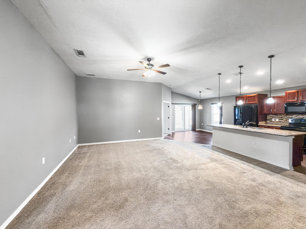 125 Lillian Way Crestview, FL 32536 - Photo 4 of 33 a view of an empty room with a kitchen