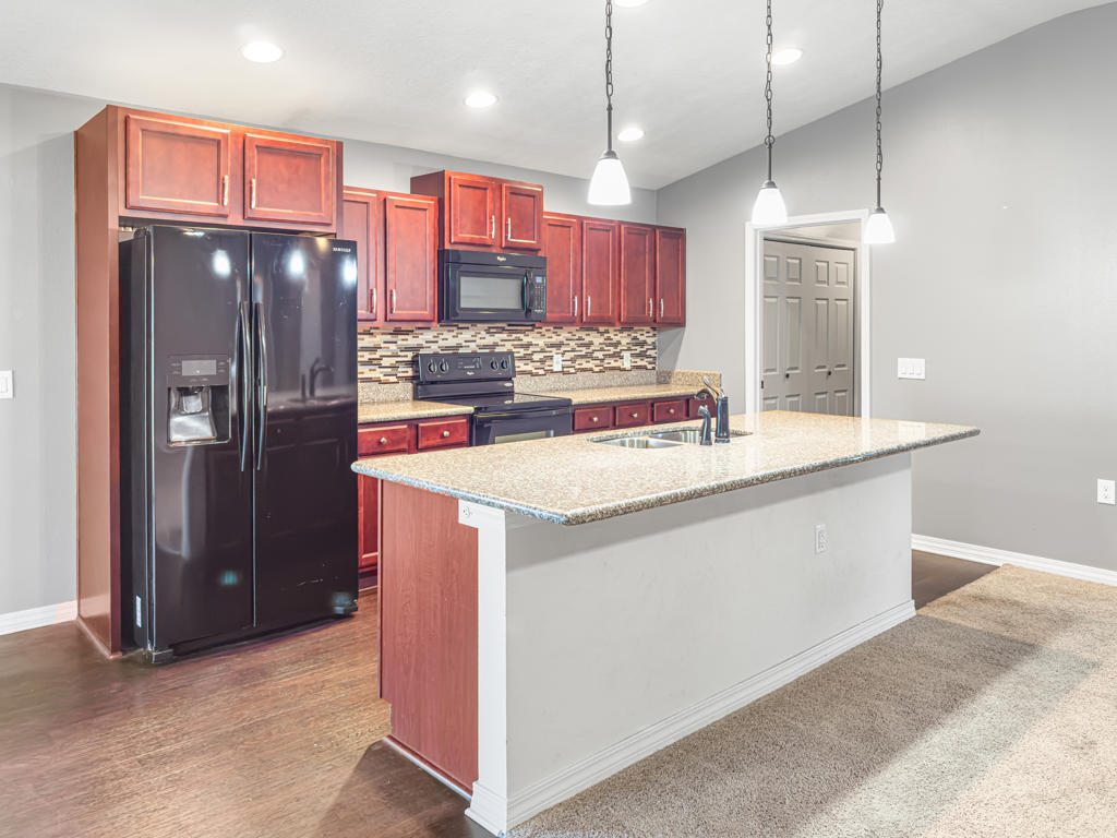 125 Lillian Way Crestview, FL 32536 - Photo 6 of 33 a kitchen with stainless steel appliances granite countertop a refrigerator a stove and a sink