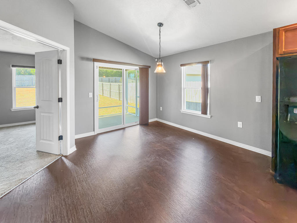 125 Lillian Way Crestview, FL 32536 - Photo 9 of 33 an empty room with wooden floor and windows