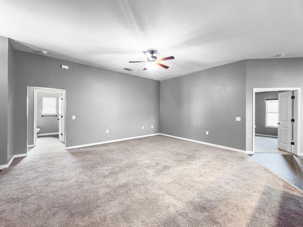 125 Lillian Way Crestview, FL 32536 - Photo 10 of 33 a view of an empty room with a ceiling fan