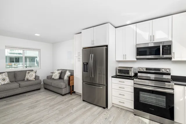 a kitchen with stainless steel appliances a stove microwave and refrigerator