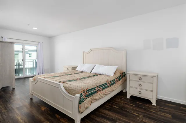 a bed sitting in a spacious bedroom next to a window