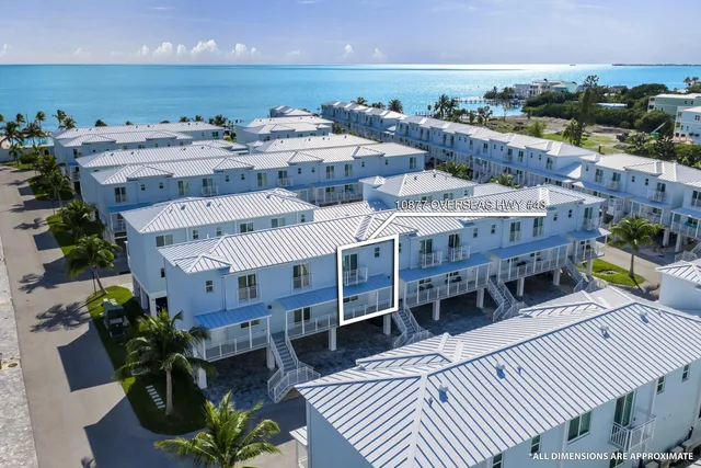 a view of a balcony with chairs and wooden floor