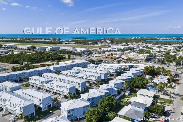 an aerial view of a building with parking