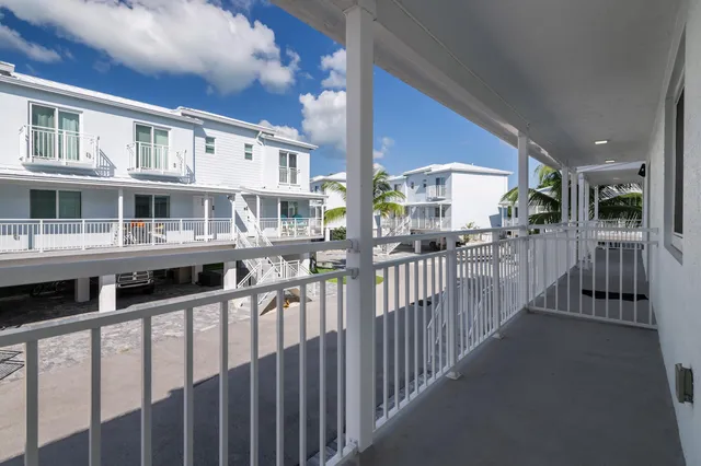 a view of a house with street from a balcony