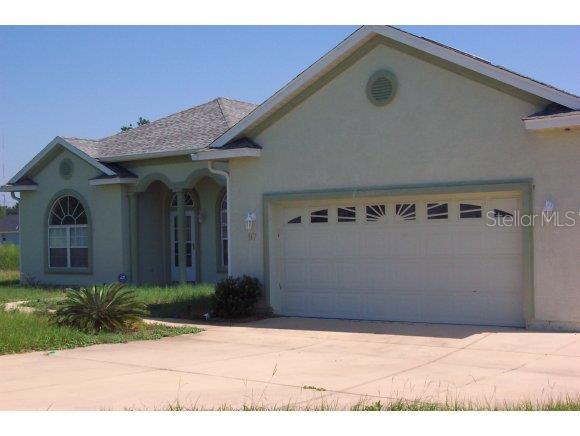 97 Juniper Loop Ocala, FL 34480 - Photo 1 of 1 a front view of a house with garden