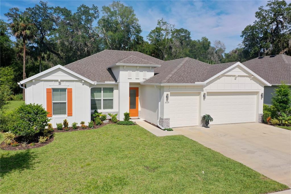 3029 Adrian Drive Ormond Beach, FL 32174 - Photo 1 of 1 a front view of a house with a yard and trees