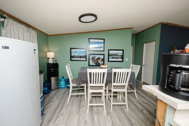 a view of a dining room with furniture and wooden floor