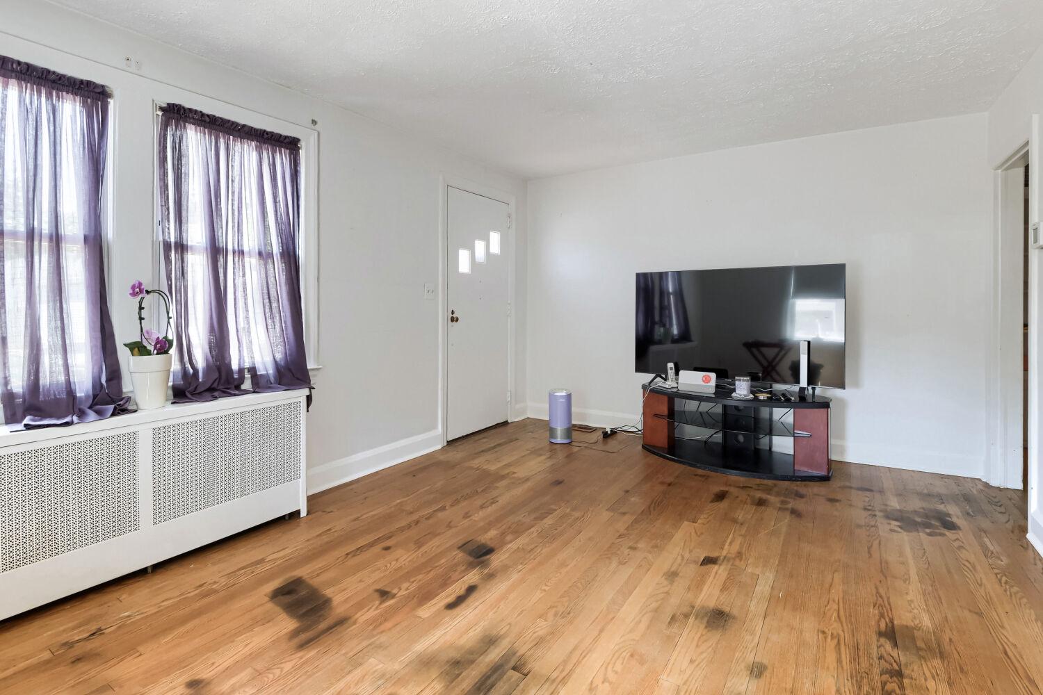 217 Doris Avenue Baltimore, MD 21225 - Photo 5 of 16 a living room with furniture and a flat screen tv