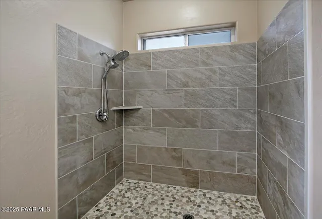 a bedroom with bed and a potted plant