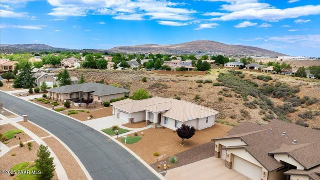 a view of a patio with couches table and chairs with wooden floor
