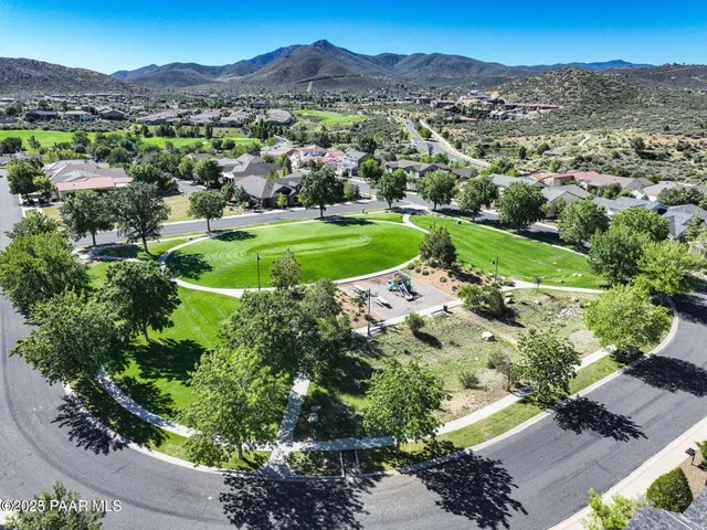 a front view of a house with a garden and parking