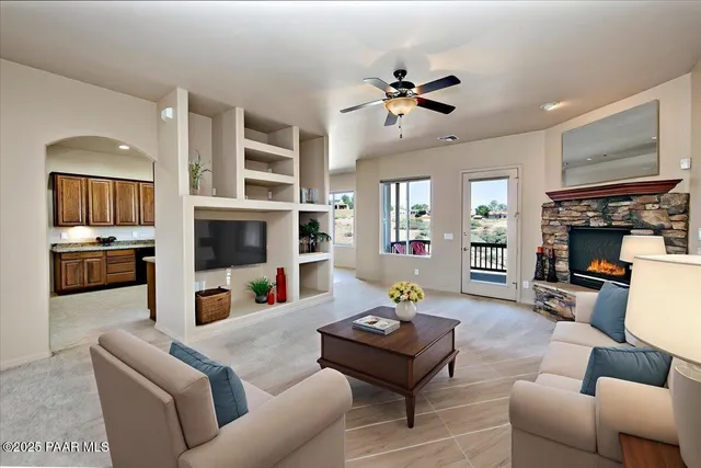 a living room with furniture and a fireplace