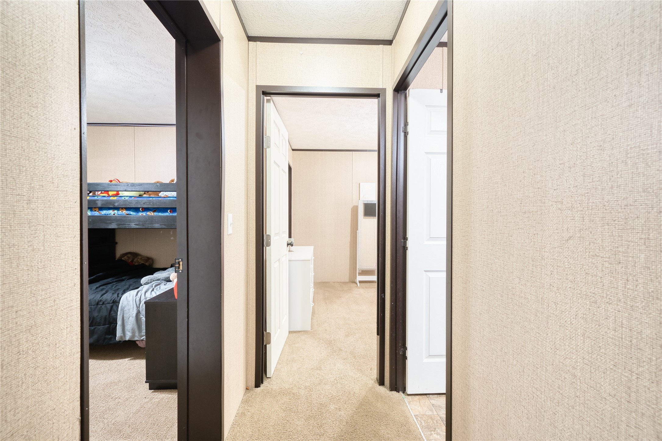 103 County Road 370 Splendora, TX 77372 - Photo 13 of 32 a view of a bedroom from a hallway