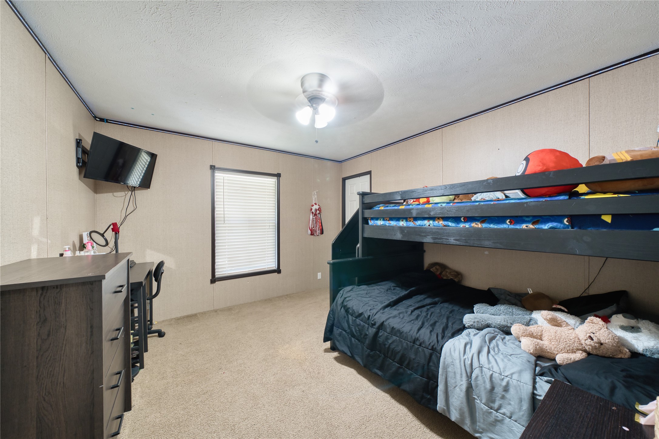 103 County Road 370 Splendora, TX 77372 - Photo 14 of 32 a bedroom with a bed and a chandelier