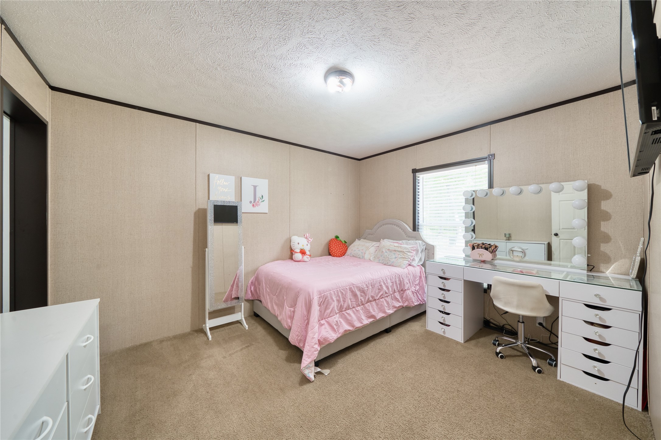 103 County Road 370 Splendora, TX 77372 - Photo 15 of 32 a bedroom with a bed and a cabinets