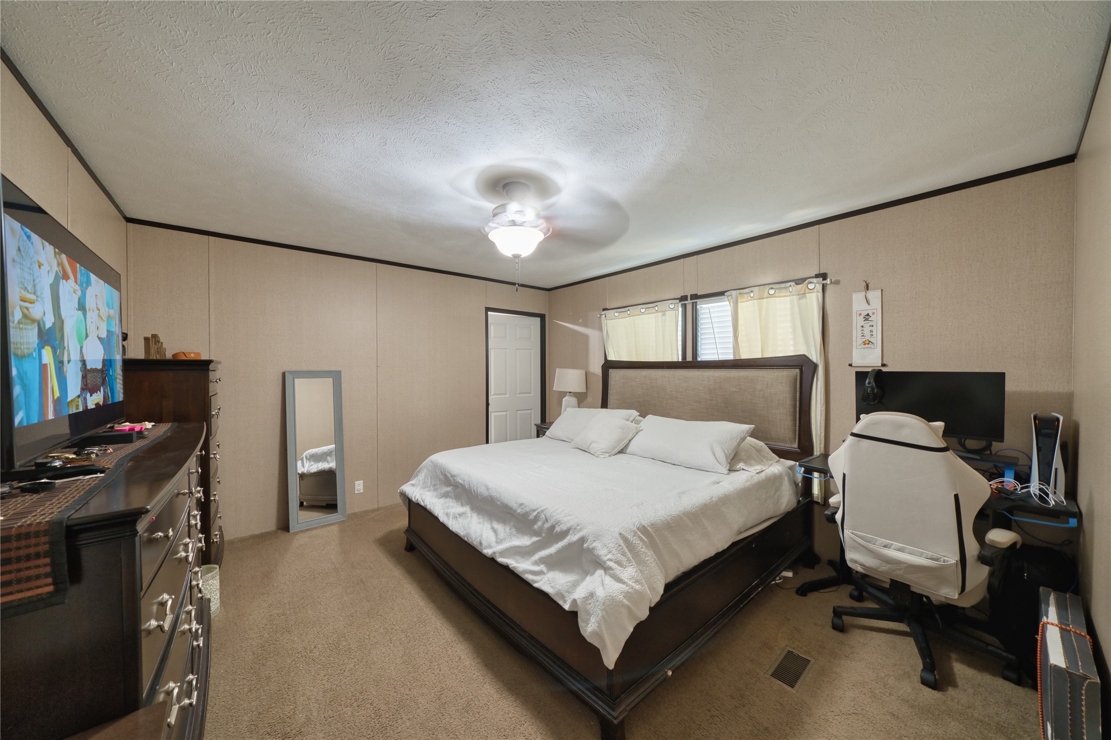 103 County Road 370 Splendora, TX 77372 - Photo 19 of 32 a bedroom with a bed and a flat screen tv