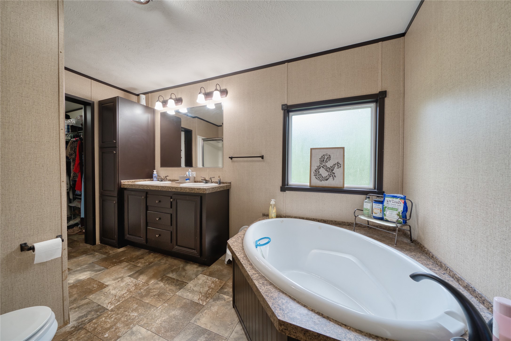 103 County Road 370 Splendora, TX 77372 - Photo 23 of 32 a en suite bathroom with a tub sink and mirror