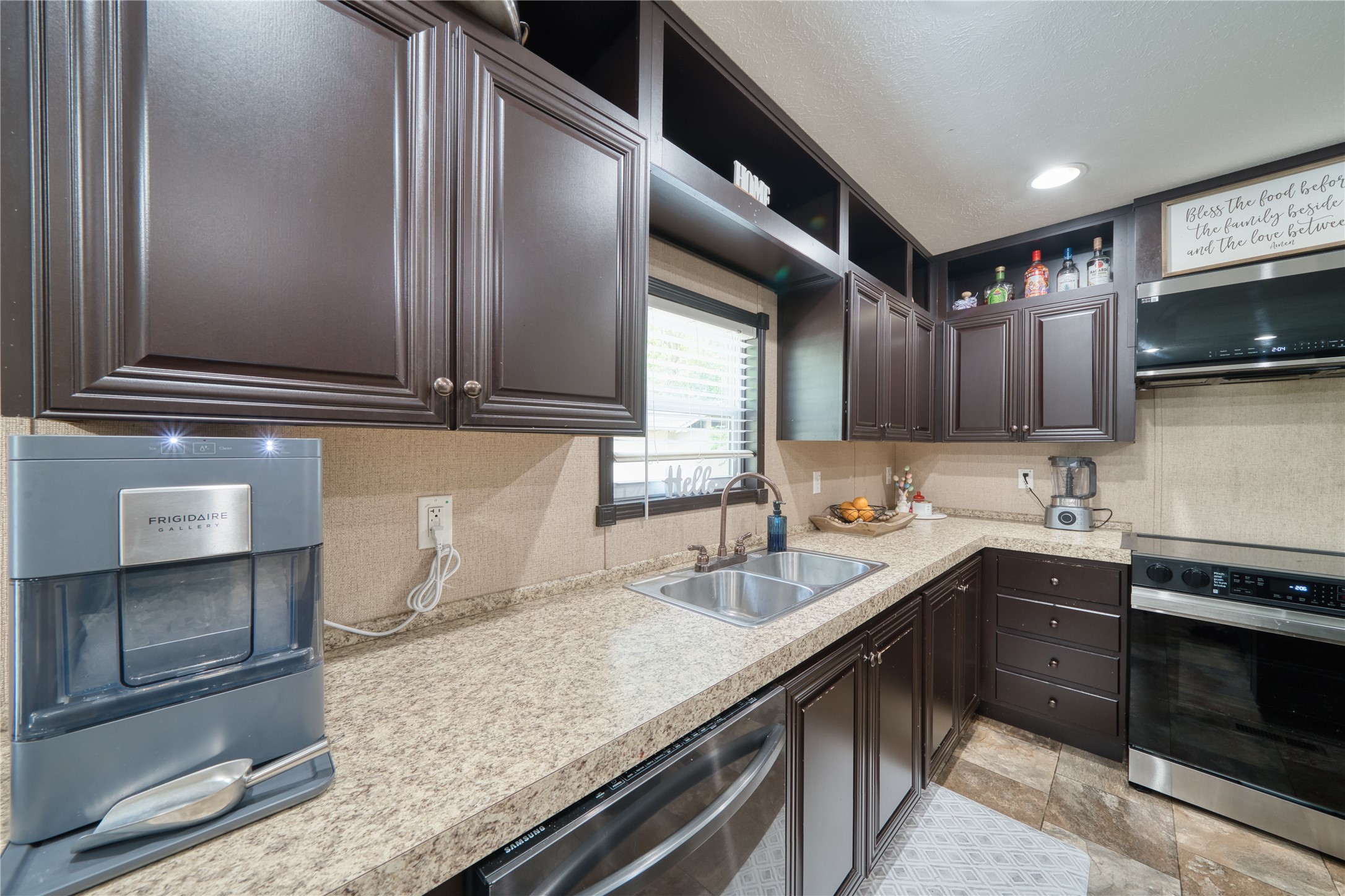 103 County Road 370 Splendora, TX 77372 - Photo 10 of 32 a kitchen with stainless steel appliances granite countertop a sink and a stove