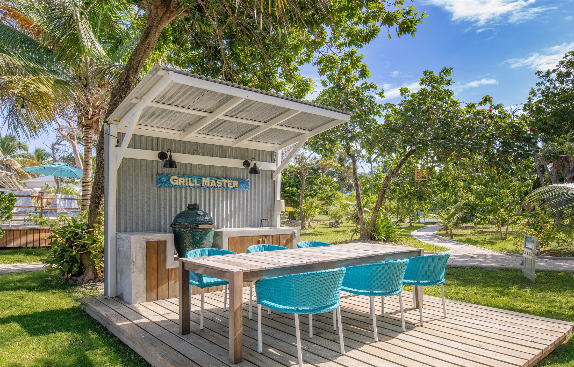7 Coconut Drive, Unit 9H undefined, undefined 00000 - Photo 11 of 19 a backyard of a house with table and chairs under an umbrella
