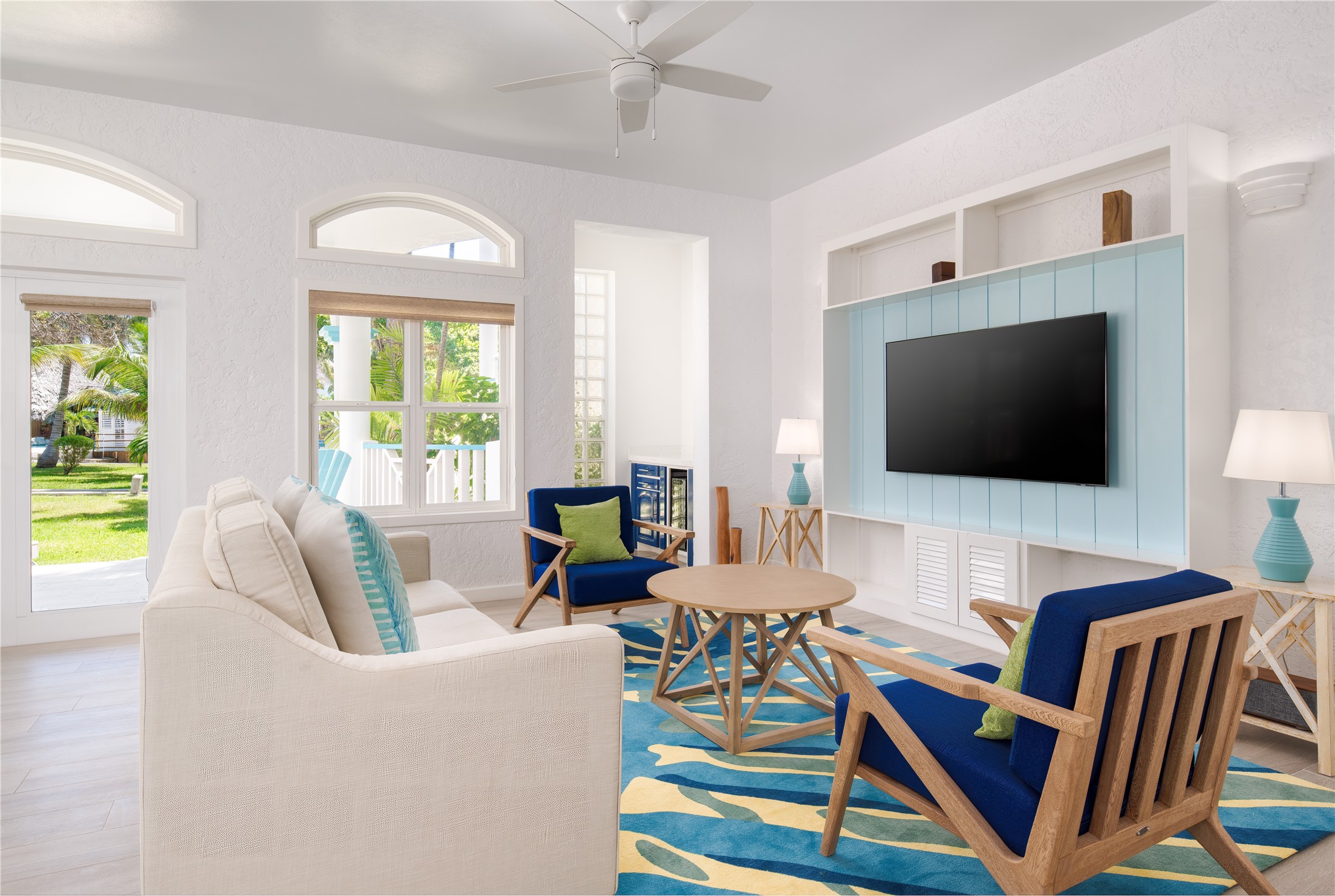 7 Coconut Drive, Unit 9H undefined, undefined 00000 - Photo 13 of 19 a living room with patio furniture and a flat screen tv