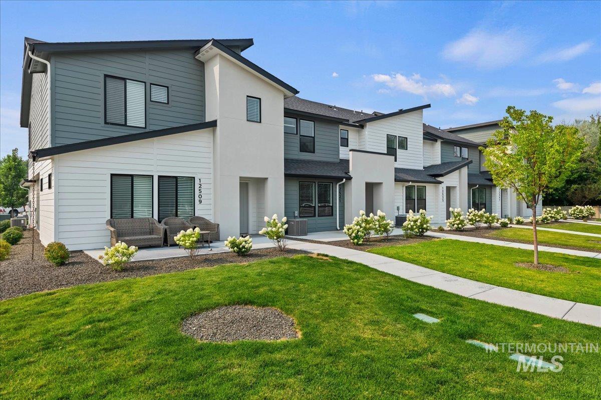 12535 West Victory Road Boise, ID 83709 - Photo 1 of 25 Contemporary exterior with mixed siding, black-framed windows, and a private patio