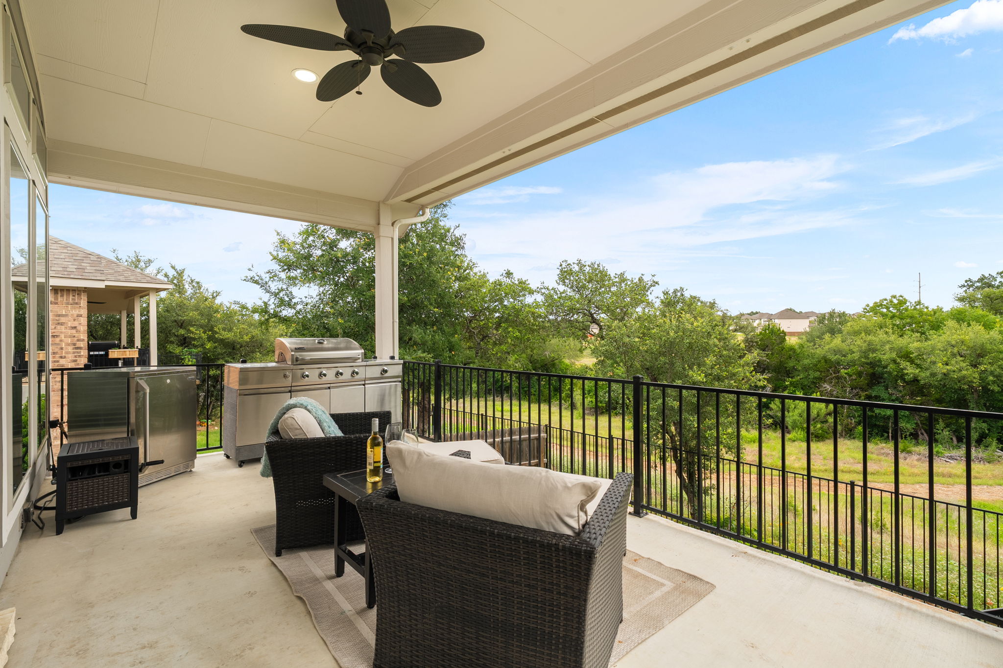 1908 Woolsey Way Leander, TX 78641 - Photo 27 of 36 A spacious covered patio offers ample room for outdoor dining and entertaining, boasting a magnificent greenbelt view.