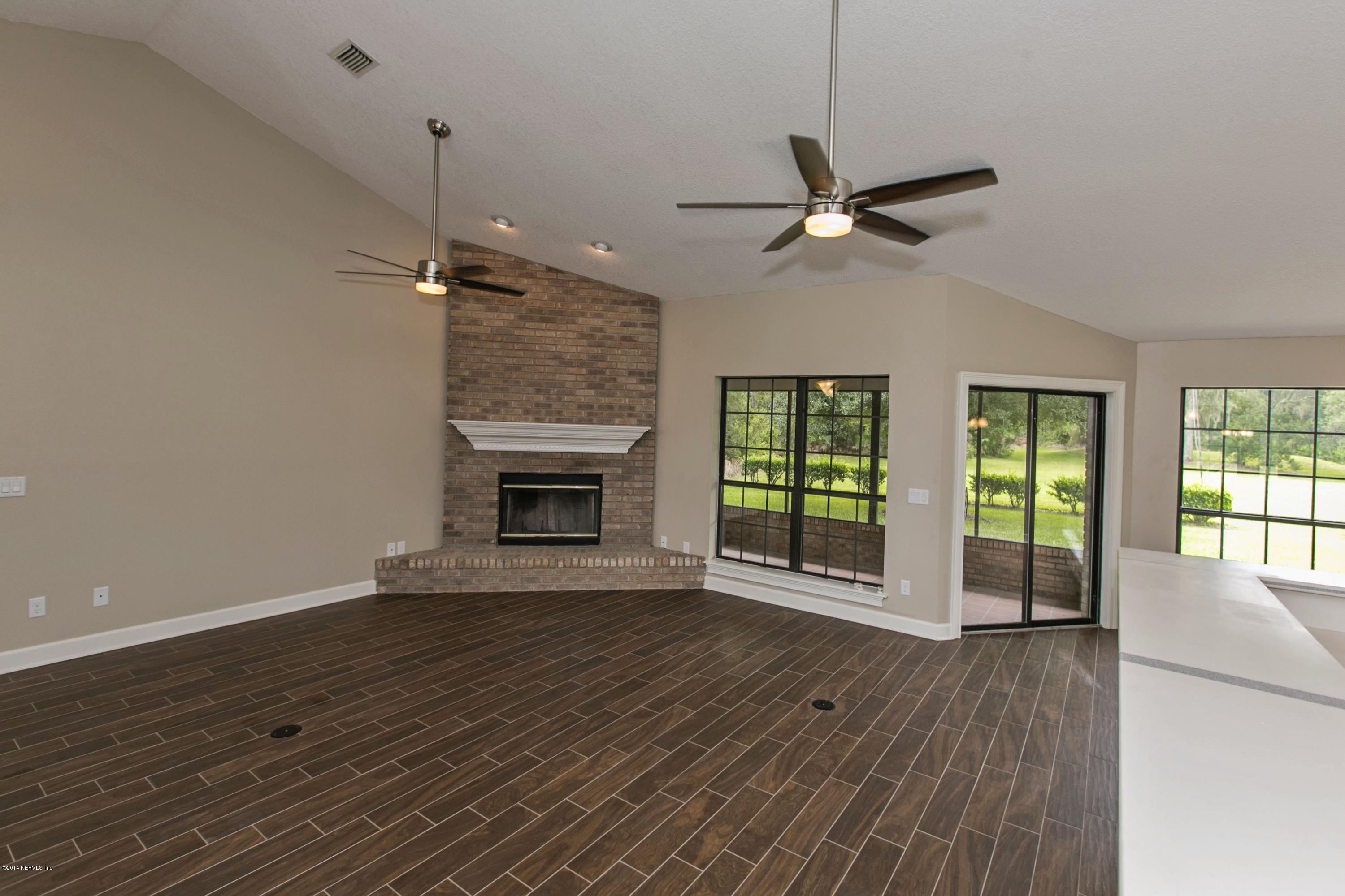 5395 D Church Road St. Augustine, FL 32092 - Photo 5 of 27 a view of an empty room with a window and wooden floor