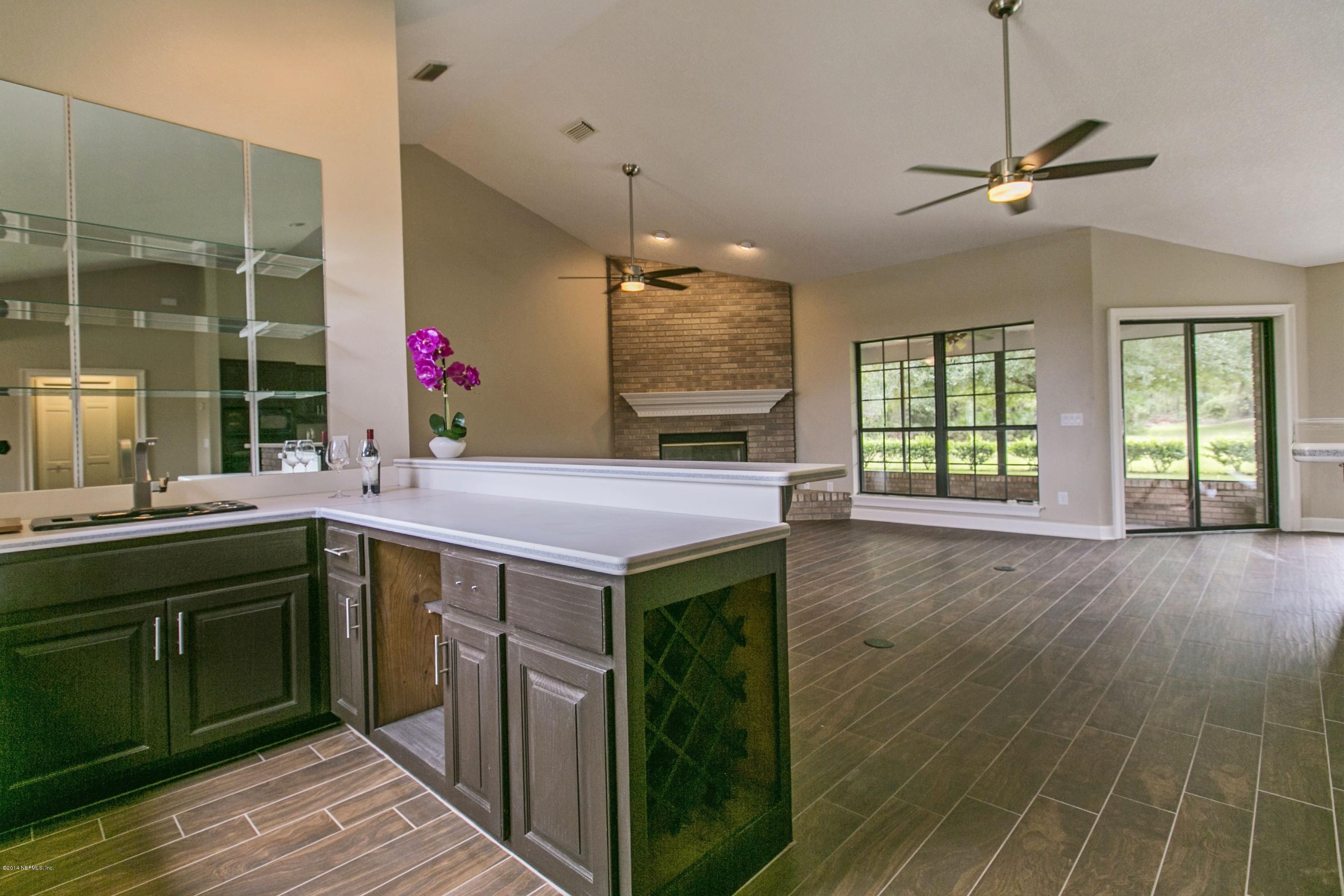 5395 D Church Road St. Augustine, FL 32092 - Photo 7 of 27 a kitchen with stainless steel appliances granite countertop a sink a stove and a wooden floors