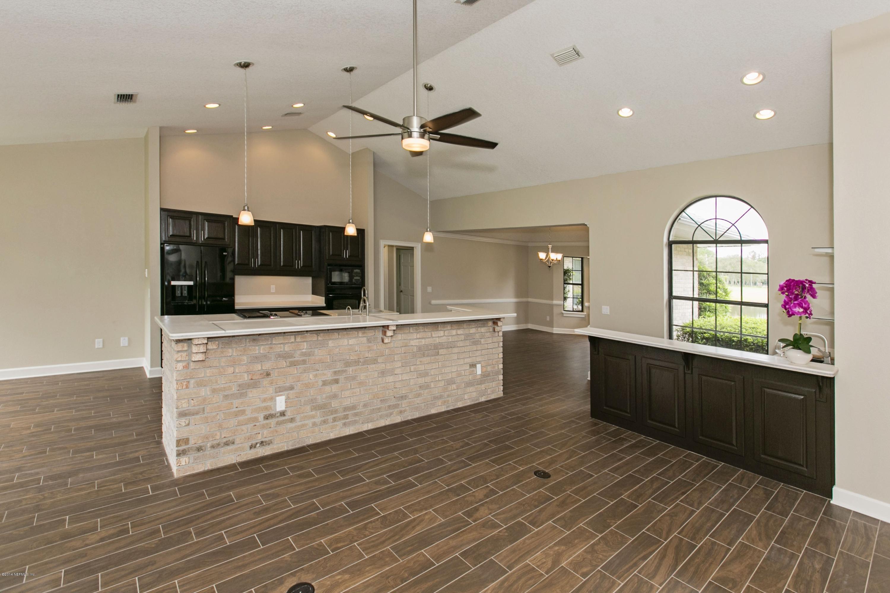 5395 D Church Road St. Augustine, FL 32092 - Photo 10 of 27 a kitchen with stainless steel appliances kitchen island wooden cabinets and granite counter tops