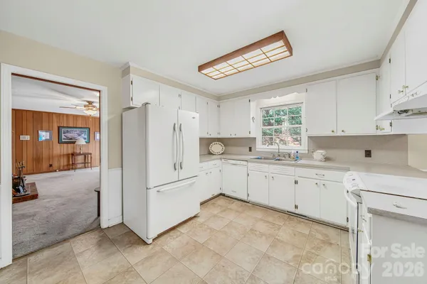 a kitchen with cabinets and a refrigerator