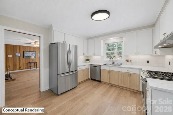 a kitchen with a refrigerator cabinets and wooden floor