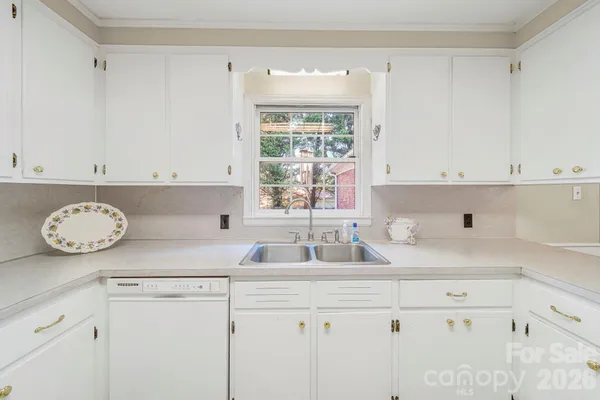a kitchen with appliances cabinets and a window