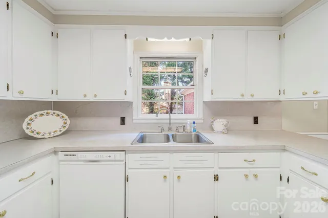 a kitchen with appliances cabinets and a window