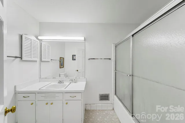 a bathroom with a sink a mirror and a shower