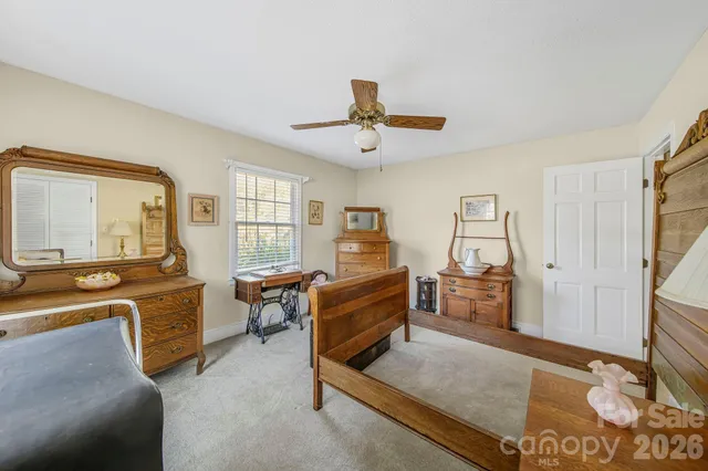 a bedroom with furniture and a window