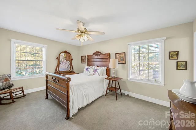 a bed room with a bed and a chair