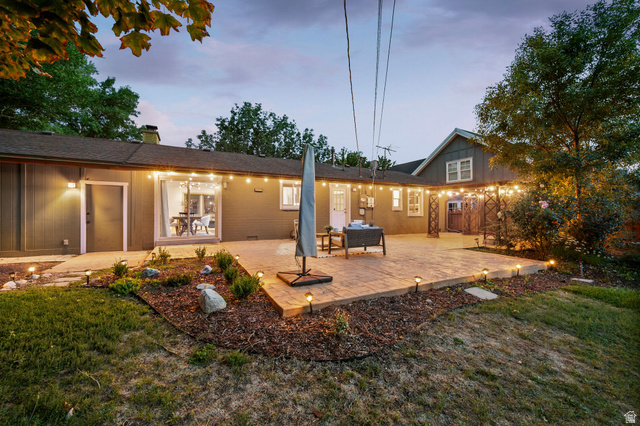 1709 Meadowmoor Road Holladay, UT 84117 - Photo 28 of 32 Expansive paver patio with string lighting and dedicated outdoor lighting