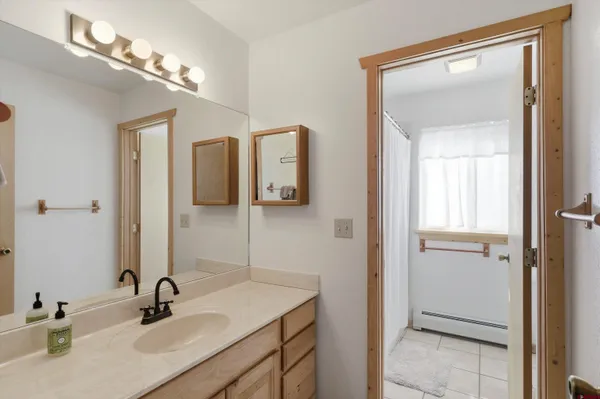 a bedroom with a bed next to a window