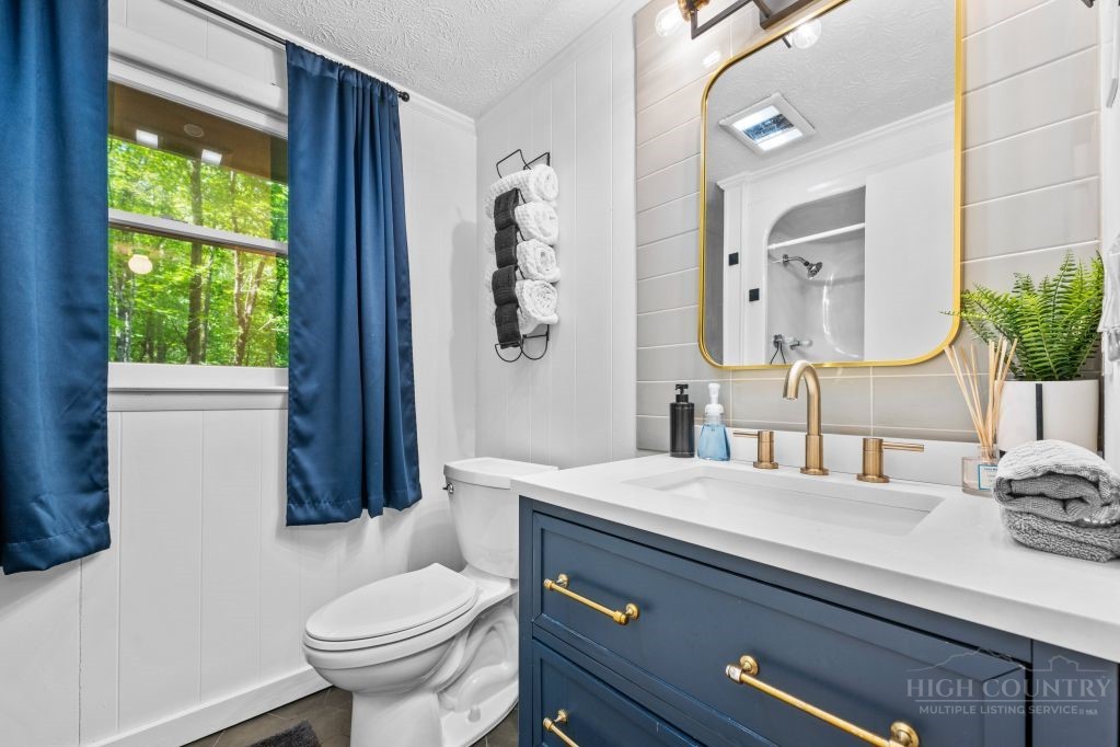 216 Saddle Lane Deep Gap, NC 28618 - Photo 19 of 44 a bathroom with a sink a toilet and shower curtain