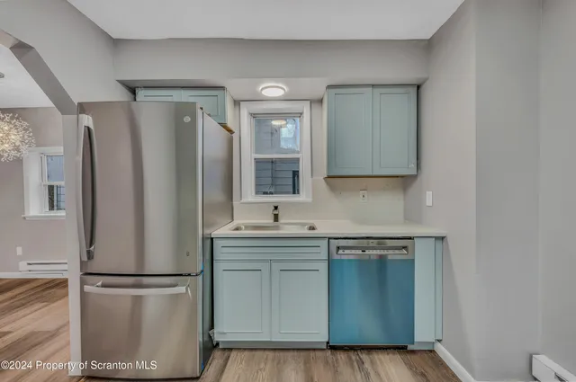 a kitchen with stainless steel appliances a refrigerator and a sink