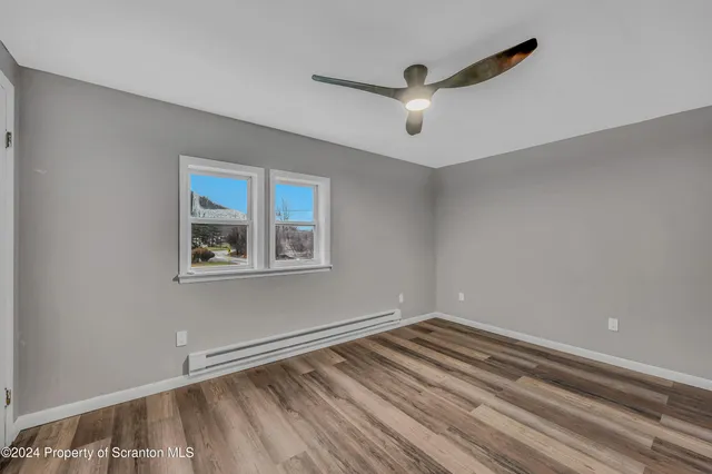 a view of room with window and ceiling fan